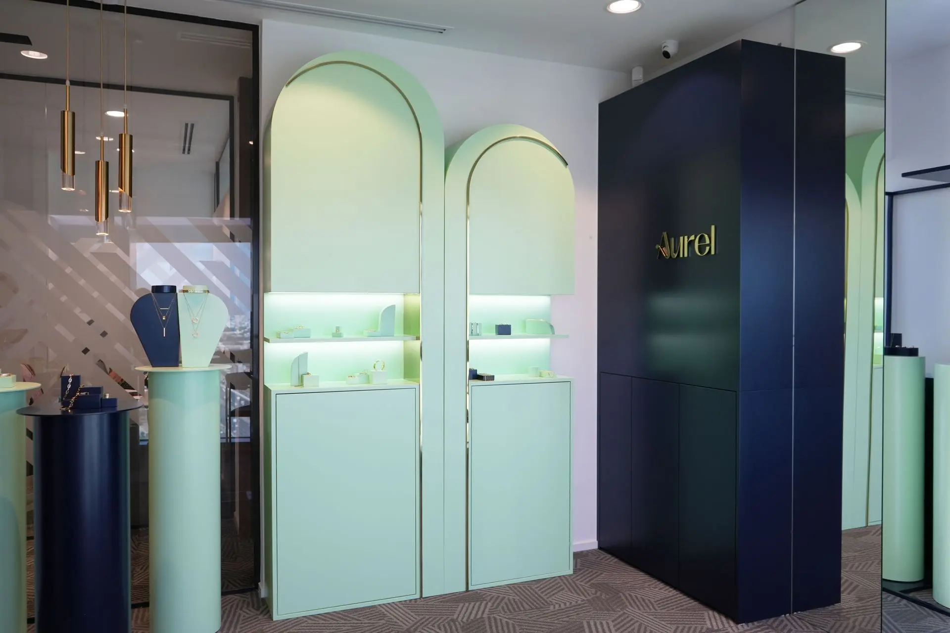 Stylish hallway with green arches and patterned flooring showroom jewellery