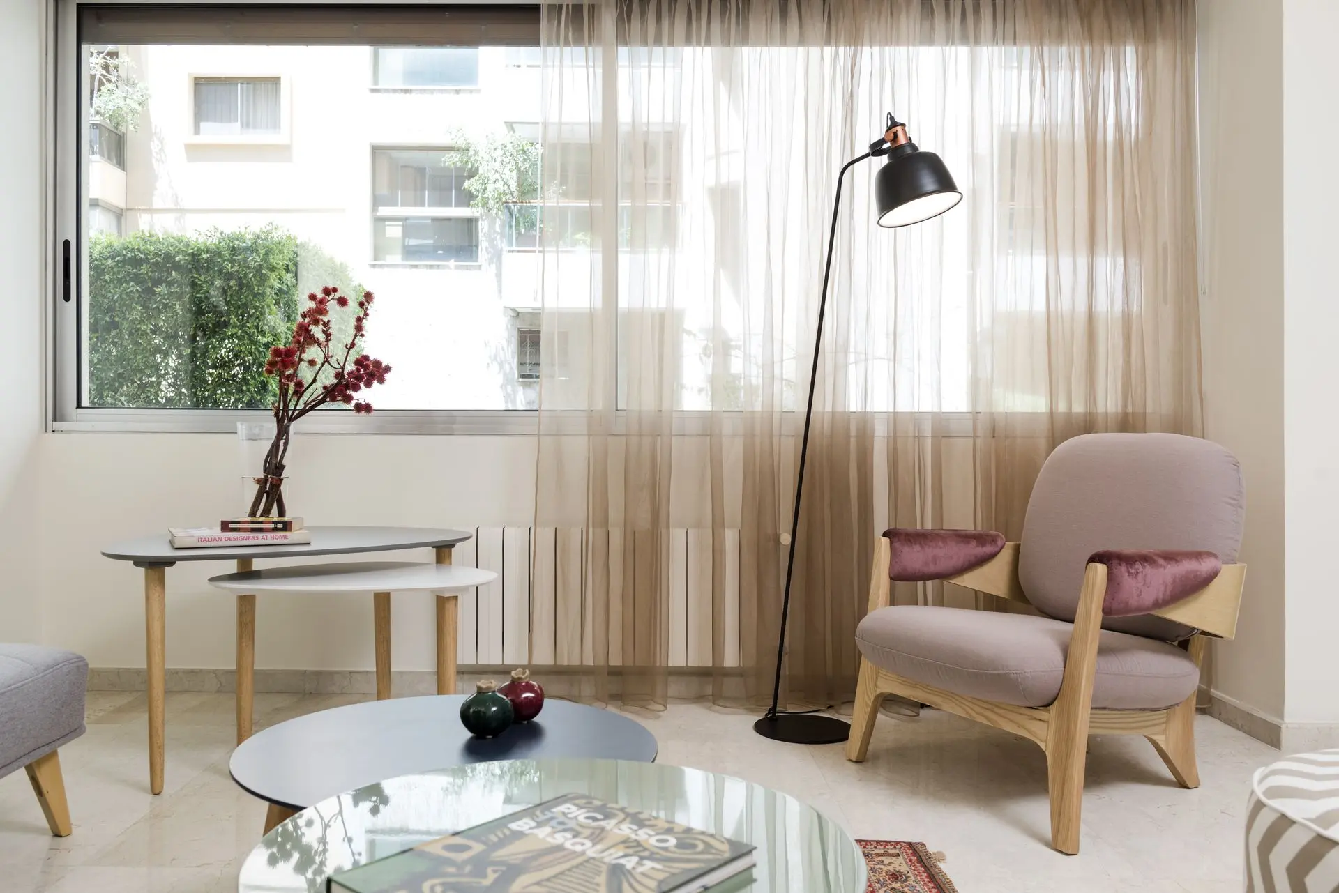 Bright and airy living space with gold chandeliers and neutral decor