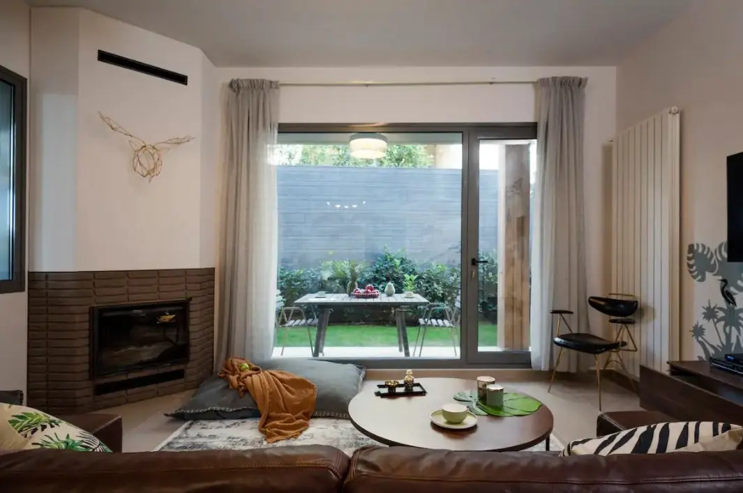 Elegant sitting area with a view of a private pool through floor-to-ceiling windows