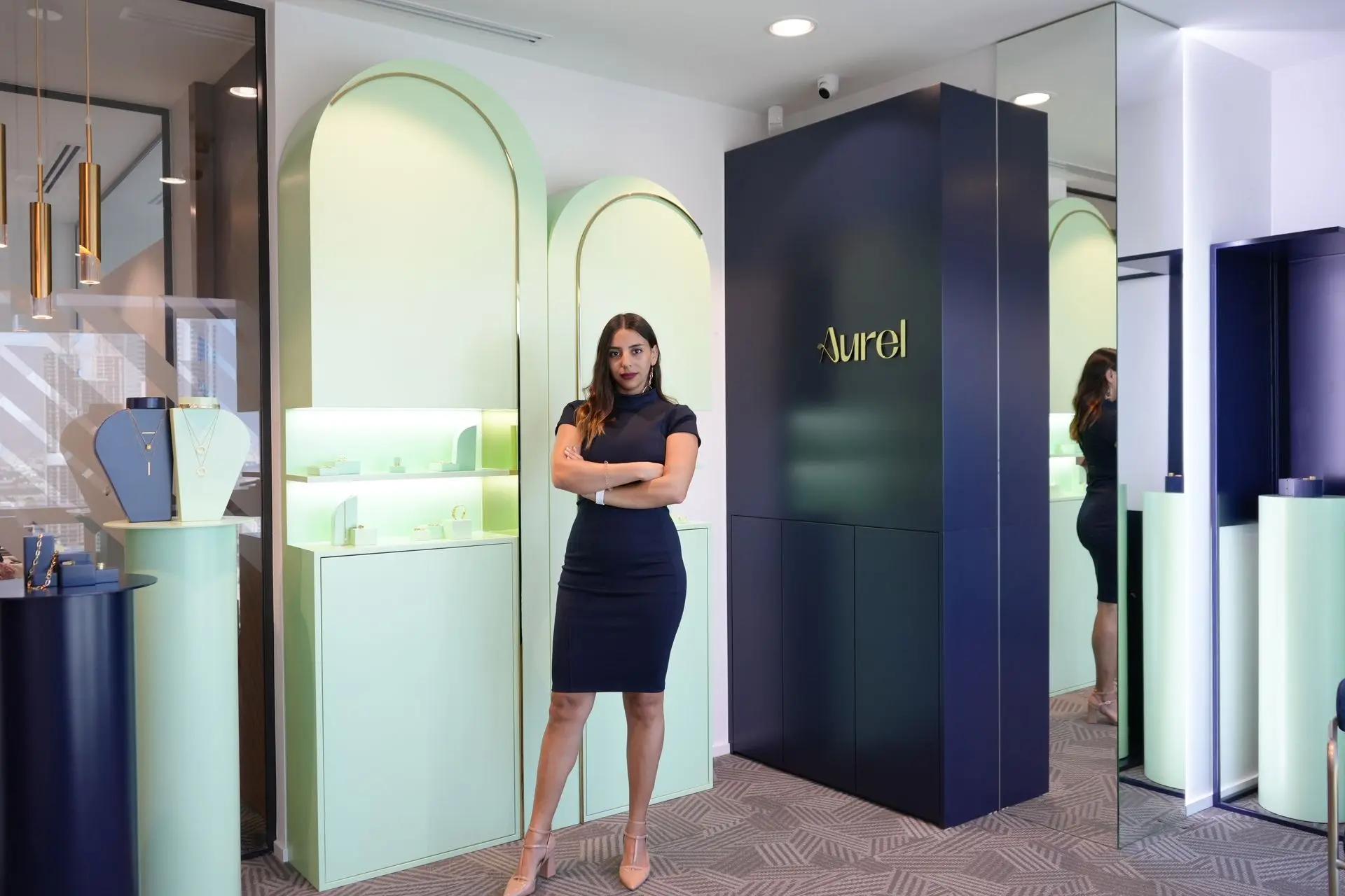 Elegant entrance area with a full-height mirror and woman standing in a luxurious interior