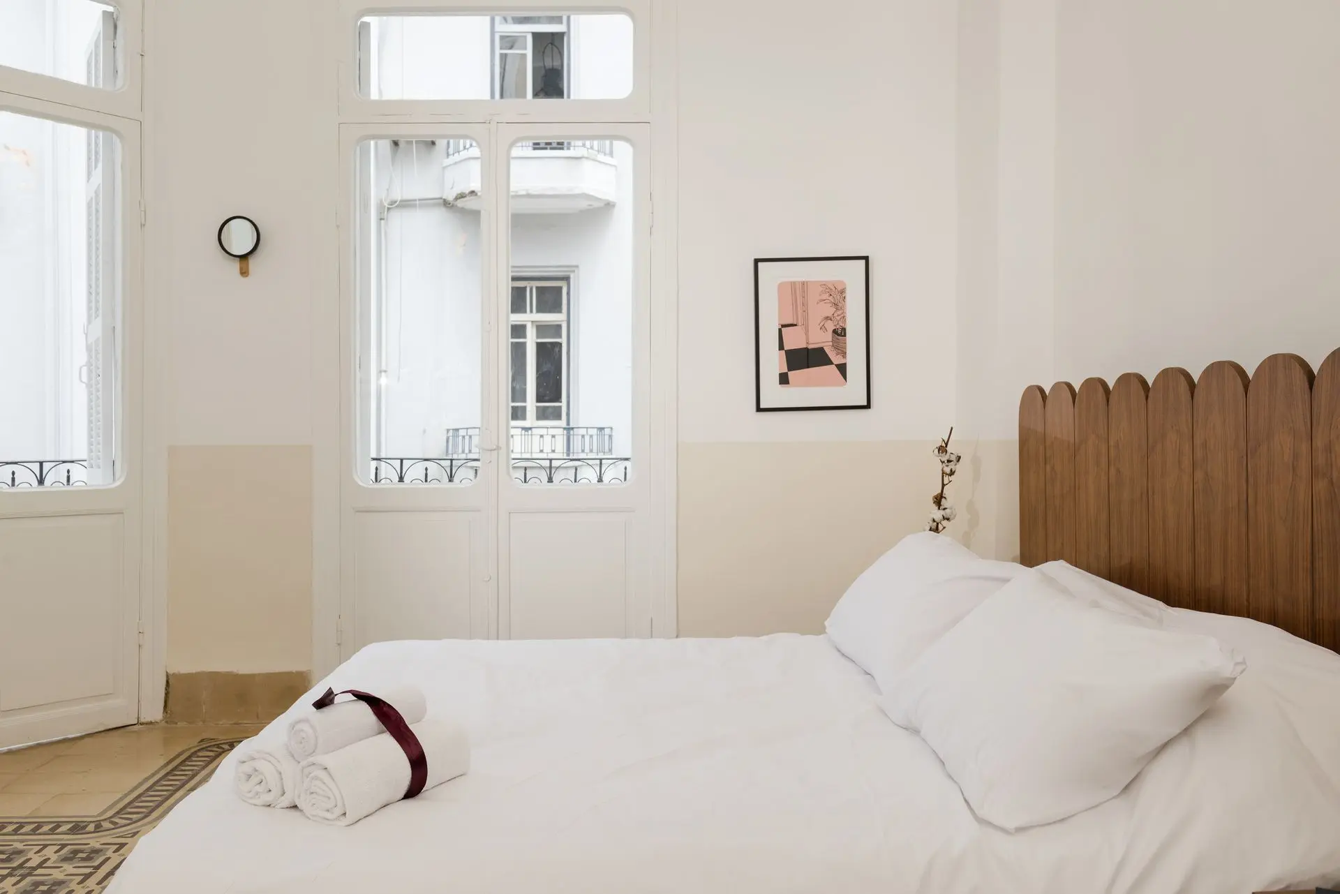 alt=&#34;White bedroom with light wood floor and modern styling&#34;