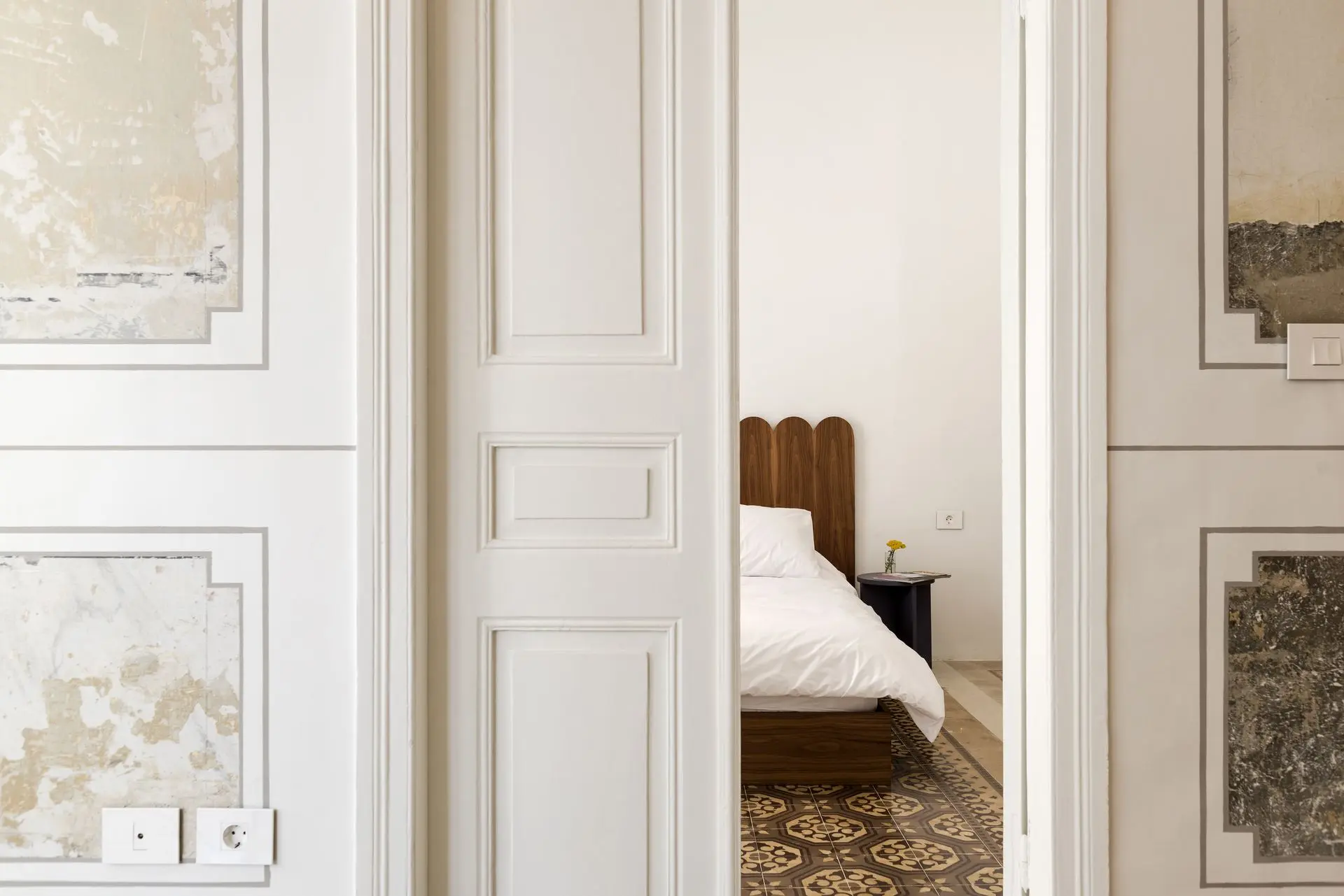 alt=&#34;White bedroom with light wood floor and modern styling&#34;