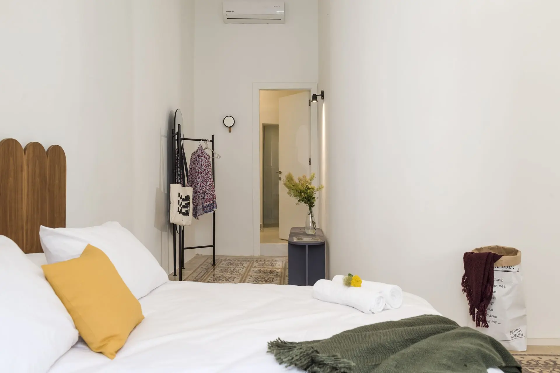 alt=&#34;White bedroom with light wood floor and modern styling&#34;