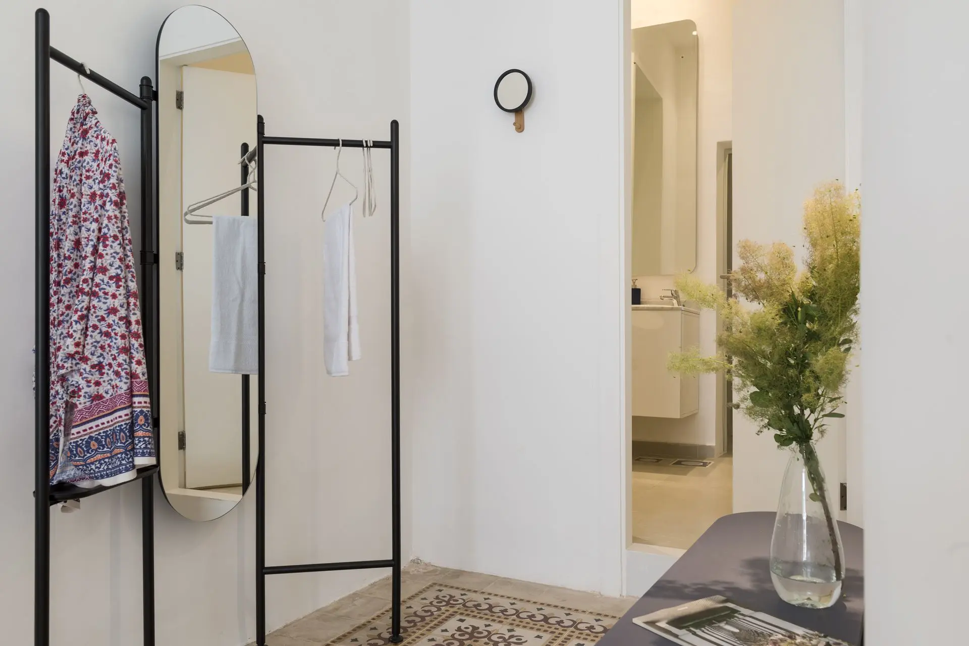 alt=&#34;White bedroom with light wood floor and modern styling&#34;
