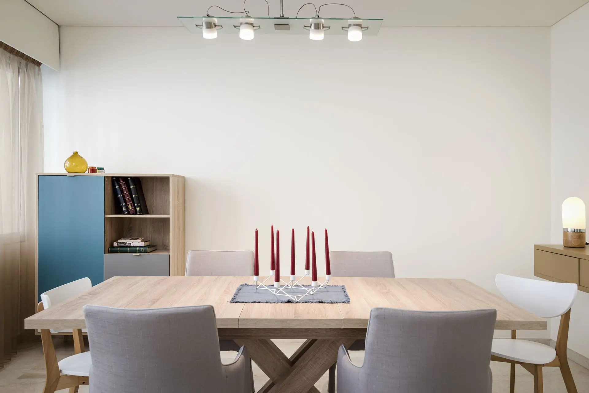 alt=&#34;Dining area with dramatic light fixture and wooden table&#34;