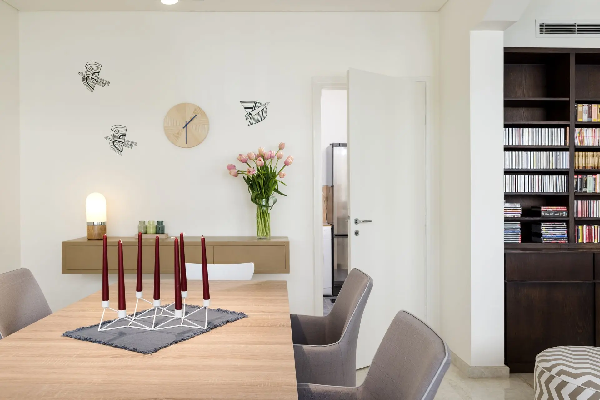 alt=&#34;Dining area with dramatic light fixture and wooden table&#34;