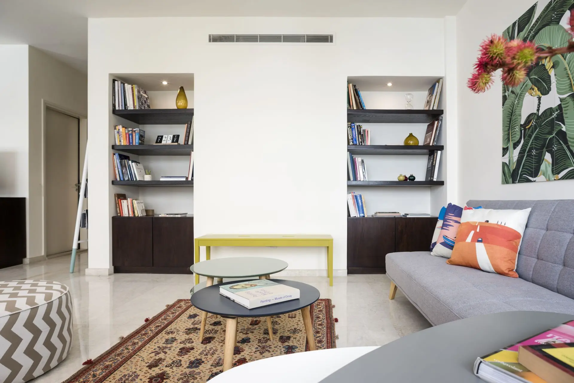 alt=&#34;Contemporary lounge with bold wall art and checkered rug&#34;