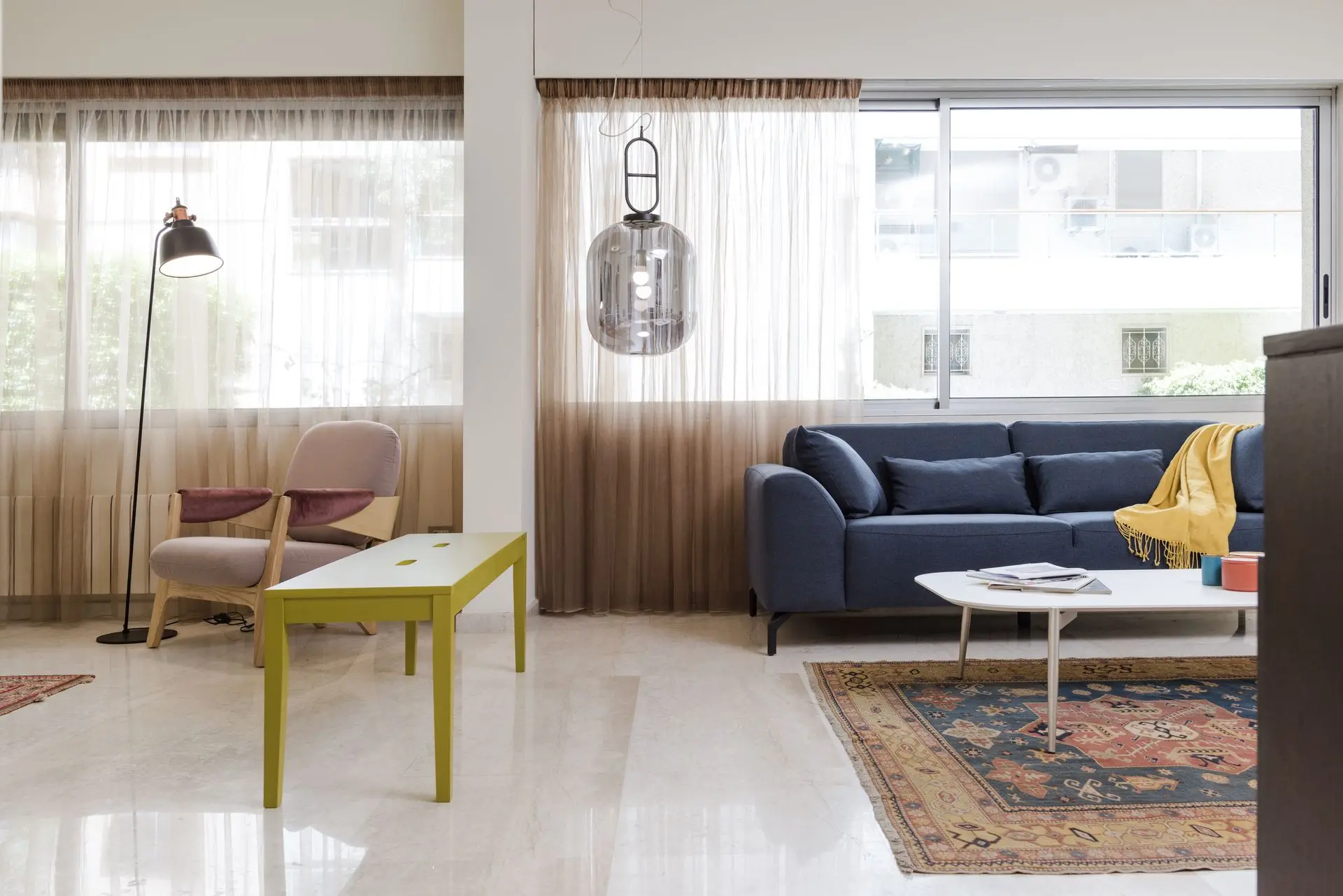 alt=&#34;Bright living room with large windows and cozy sofa&#34;