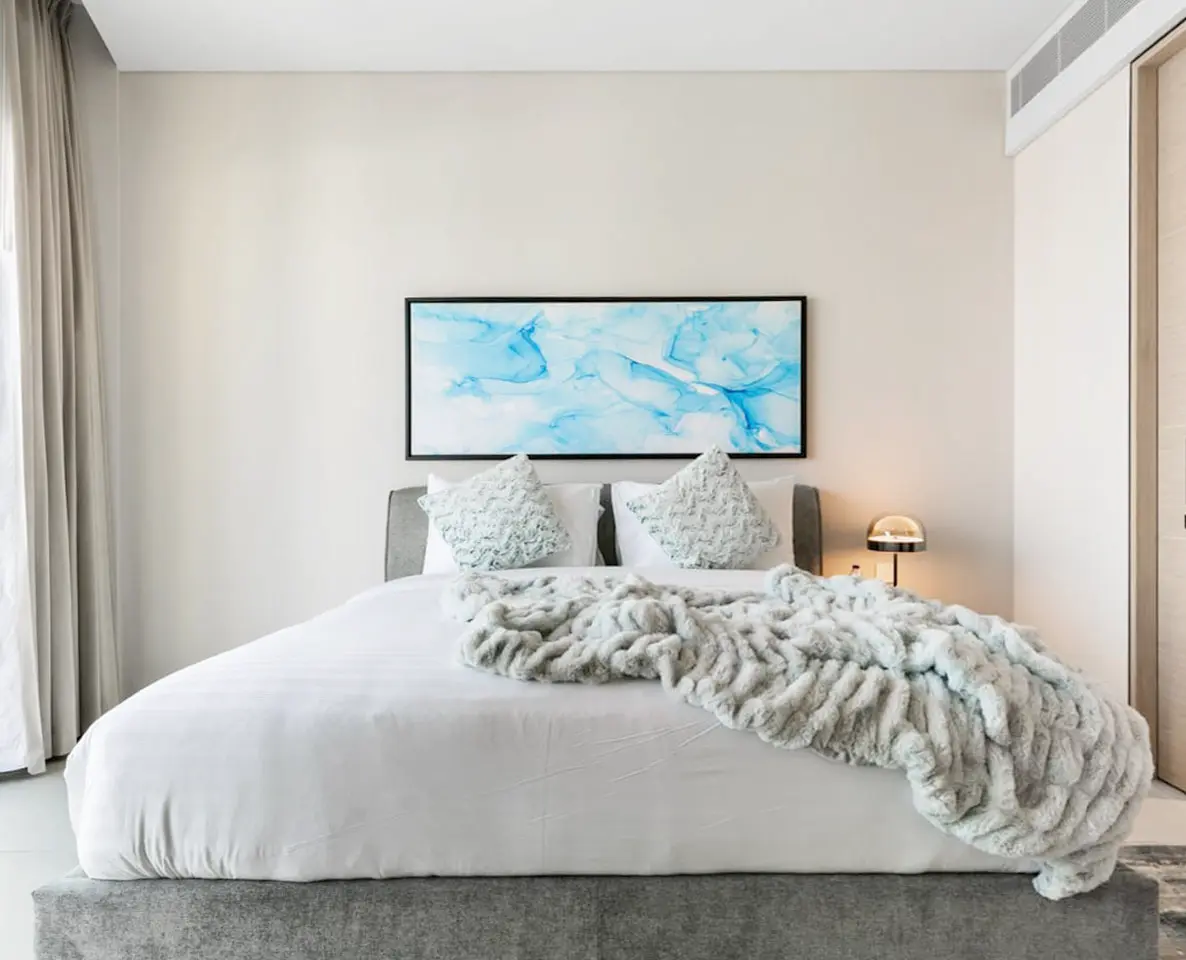 alt=&#34;Hotel-style bedroom suite with natural light and statement bed&#34;