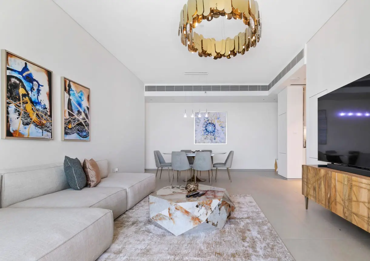 alt=&#34;Modern Dubai living room with chandelier and large windows&#34;