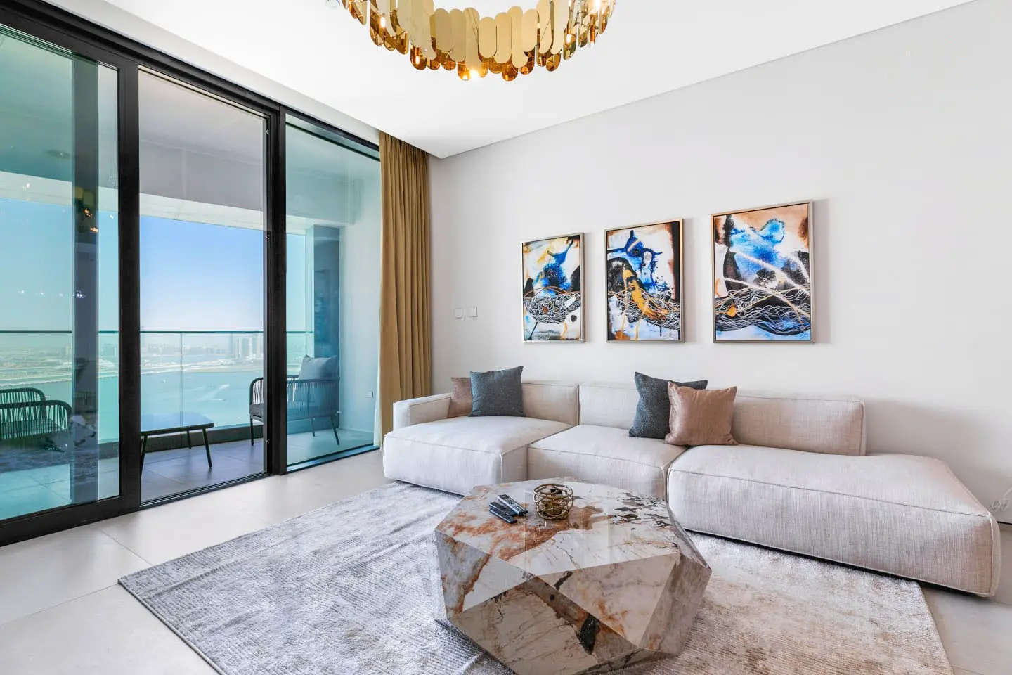 alt=&#34;Modern Dubai living room with chandelier and large windows&#34;