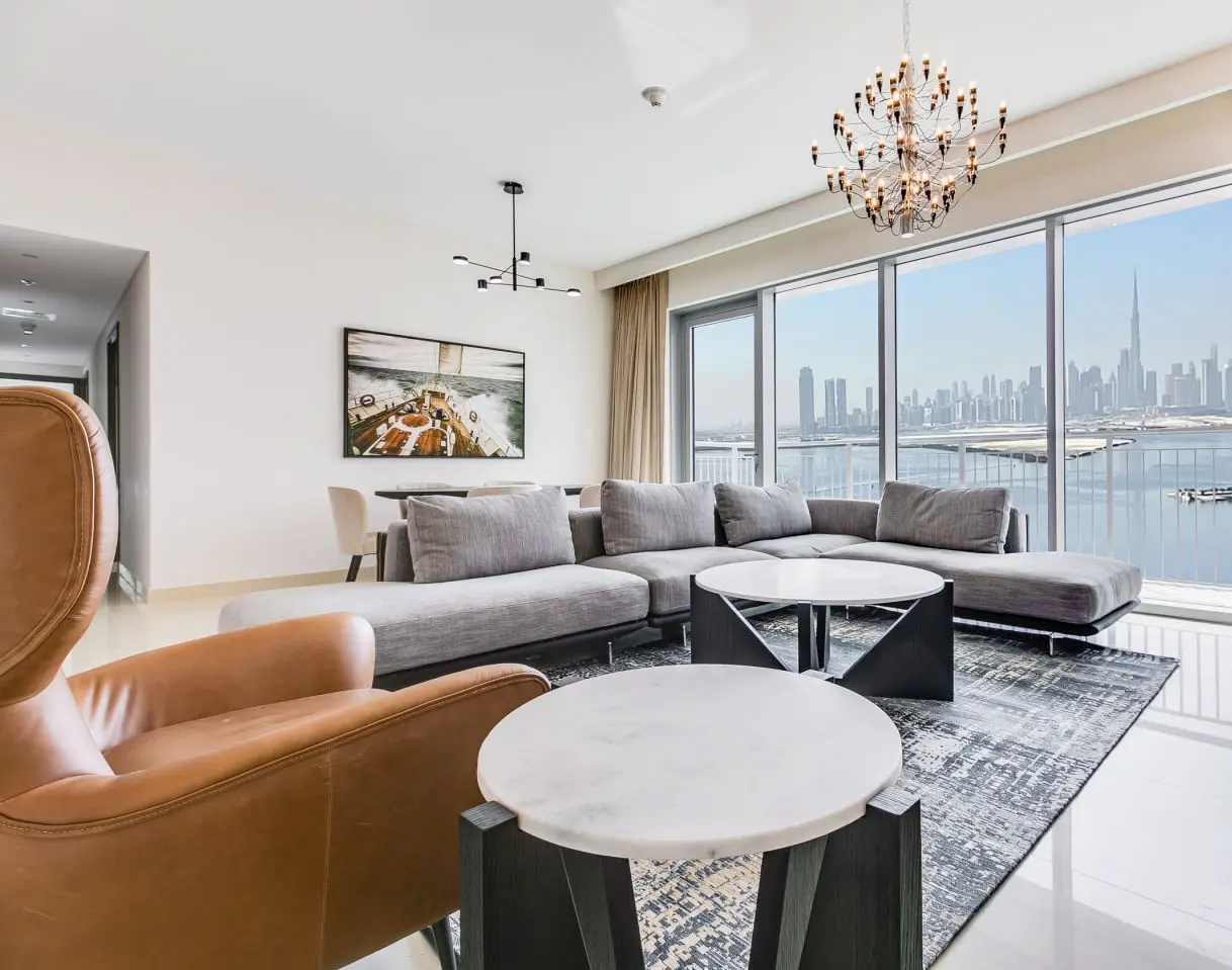 alt=&#34;Modern Dubai living room with chandelier and large windows&#34;